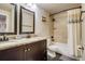 Well-lit bathroom with a double sink vanity and shower over tub at 120 S Pennsylvania St # 302, Denver, CO 80209