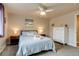 Stylized bedroom with a ceiling fan, a comfortable bed, and modern dressers and nightstands at 120 S Pennsylvania St # 302, Denver, CO 80209