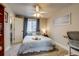 Bedroom with natural light, comfortable bed, and functional workspace at 120 S Pennsylvania St # 302, Denver, CO 80209