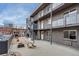 Modern apartment building exterior with balconies, fire pit, and outdoor stairs at 120 S Pennsylvania St # 302, Denver, CO 80209