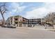Apartment building with street parking, balconies, and outdoor stairs at 120 S Pennsylvania St # 302, Denver, CO 80209