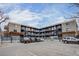 Apartment building with parking, outdoor stairs, and a pergola at 120 S Pennsylvania St # 302, Denver, CO 80209