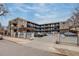 Apartment building with parking and surrounding landscape at 120 S Pennsylvania St # 302, Denver, CO 80209