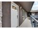 Hallway exterior showcasing apartment doors, with an open railing and painted brick at 120 S Pennsylvania St # 302, Denver, CO 80209