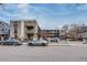 Exterior view of an apartment building with parking and street access at 120 S Pennsylvania St # 302, Denver, CO 80209