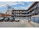 Apartment building exterior featuring parking, outdoor stairs, and a pergola at 120 S Pennsylvania St # 302, Denver, CO 80209