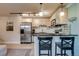 Open-concept kitchen with stainless steel appliances, breakfast bar and stylish cabinetry at 120 S Pennsylvania St # 302, Denver, CO 80209