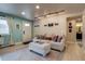 Bright living room with a cozy couch, soft lighting and a view of the bathroom at 120 S Pennsylvania St # 302, Denver, CO 80209