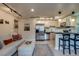 Inviting living room with breakfast bar, modern kitchen, and comfortable seating arrangement at 120 S Pennsylvania St # 302, Denver, CO 80209