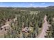 Overhead view showcases a home surrounded by dense forest and serene landscape, perfect for nature lovers at 8722 S Ault Ln, Morrison, CO 80465