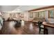 Spacious finished basement featuring hardwood floors, ping pong table, and comfortable seating at 8722 S Ault Ln, Morrison, CO 80465