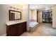 Bathroom with soaking tub, vanity with sink, and walk-in closet at 8722 S Ault Ln, Morrison, CO 80465