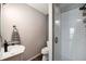 Modern bathroom with stylish vanity, toilet, and glass-enclosed shower at 8722 S Ault Ln, Morrison, CO 80465