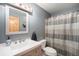 Bathroom featuring a vanity with sink, toilet, and shower with curtain at 8722 S Ault Ln, Morrison, CO 80465