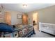 Bedroom with unique decor, shelving, and attached baby crib at 8722 S Ault Ln, Morrison, CO 80465