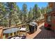 Spacious deck with outdoor dining furniture and a grill, perfect for entertaining with scenic views at 8722 S Ault Ln, Morrison, CO 80465