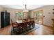 Charming dining room with a classic chandelier and sliding glass doors to the outdoor space at 8722 S Ault Ln, Morrison, CO 80465