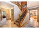 Welcoming hallway featuring tiled floors, staircase, and seamless transition to other areas at 8722 S Ault Ln, Morrison, CO 80465