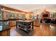 Bright kitchen with wood cabinets, granite countertops, an island, and a view of the living area at 8722 S Ault Ln, Morrison, CO 80465