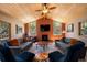 Inviting living room featuring a fireplace, vaulted ceilings, and large windows for natural light at 8722 S Ault Ln, Morrison, CO 80465