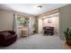 Bright living room with a desk, a potted plant, and a comfy sofa by the window at 8722 S Ault Ln, Morrison, CO 80465