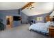 Main bedroom with fireplace, vaulted ceilings, walk-in closet, and sitting area at 8722 S Ault Ln, Morrison, CO 80465