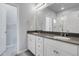 Bathroom featuring double sinks with gray countertops and white cabinets at 12738 Boggs St, Parker, CO 80134