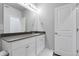 Bathroom featuring a single sink with gray countertops, white cabinets, and a large mirror at 12738 Boggs St, Parker, CO 80134