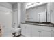 Bathroom featuring a shower and tub combo, vanity with gray countertops, and white cabinets at 12738 Boggs St, Parker, CO 80134