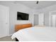 A view of a bedroom showcasing a TV, dresser, and neutral color scheme at 12738 Boggs St, Parker, CO 80134