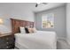 Bedroom featuring a wooden headboard bed, a side table with a lamp, and a window at 12738 Boggs St, Parker, CO 80134