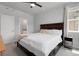 Bright bedroom with a large window and a dark wood bed frame with storage drawers at 12738 Boggs St, Parker, CO 80134