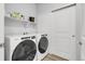 Laundry room featuring a Whirlpool washer and dryer with a shelf above at 12738 Boggs St, Parker, CO 80134