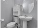 Stylish powder room featuring a modern vanity, round mirror, and clean, neutral decor at 12738 Boggs St, Parker, CO 80134
