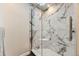 Elegant bathroom features a marble-tiled shower with a glass door and modern fixtures at 1600 S Quebec Way # 8, Denver, CO 80231