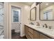 Bathroom with a double vanity, stylish mirrors, and a separate toilet room at 1600 S Quebec Way # 8, Denver, CO 80231