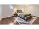 Inviting bedroom with stylish rug, hardwood floors, and a unique octagonal window at 1600 S Quebec Way # 8, Denver, CO 80231
