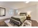 Relaxing bedroom with hardwood floors, an area rug, and natural light from an octagonal window at 1600 S Quebec Way # 8, Denver, CO 80231