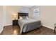 Comfortable bedroom featuring dark hardwood floors and natural light from two windows at 1600 S Quebec Way # 8, Denver, CO 80231