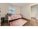Bright bedroom with hardwood floors, a twin bed, and a neutral color scheme at 1600 S Quebec Way # 8, Denver, CO 80231
