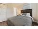 Well-lit bedroom showcases stylish bedding, a window, and a convenient closet at 1600 S Quebec Way # 8, Denver, CO 80231
