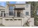 Charming two-story stucco home with a balcony, two-car garage, and a decorative circular window at 1600 S Quebec Way # 8, Denver, CO 80231
