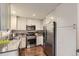 Bright kitchen with stainless steel appliances, modern white cabinetry, and ample counter space at 1600 S Quebec Way # 8, Denver, CO 80231