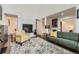 Cozy living room featuring a fireplace, hardwood floors, and comfortable modern furniture at 1600 S Quebec Way # 8, Denver, CO 80231