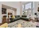 Spacious living room with a large window, hardwood floors, and comfortable modern decor at 1600 S Quebec Way # 8, Denver, CO 80231