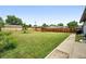 Large backyard with lush green grass and a wood fence for privacy at 2011 S Vallejo St, Denver, CO 80223