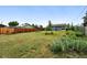 Large grassy backyard with wood fence and landscaping at 2011 S Vallejo St, Denver, CO 80223