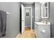 Bathroom with gray walls and a white vanity featuring a mirror and modern fixtures at 2011 S Vallejo St, Denver, CO 80223