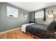 Bedroom with wood floors and gray walls highlighted by the natural light from the window at 2011 S Vallejo St, Denver, CO 80223