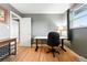 Bedroom with hardwood floors set up as an office with a modern desk and ample natural light at 2011 S Vallejo St, Denver, CO 80223